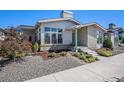 Inviting gray home with modern design, stone accents, and professionally landscaped front yard at 10179 E 59Th North Pl, Denver, CO 80238