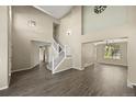 Bright, open-concept living room featuring high ceilings and updated flooring at 5010 Apache Creek Rd, Castle Rock, CO 80109