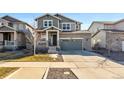 Charming two-story home with a stone and siding exterior and well-maintained landscaping at 26304 E 4Th Pl, Aurora, CO 80018