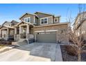 Attractive two-story home with a stone facade, a covered front porch, and an attached two-car garage at 26304 E 4Th Pl, Aurora, CO 80018