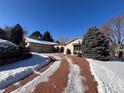 Brick ranch home with attached two-car garage and basketball hoop at 3 Columbine Ln, Littleton, CO 80123