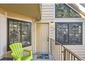 Townhouse front door with lime green chair, unique doorbell and stone accents at 4832 E Kentucky Ave # E, Denver, CO 80246