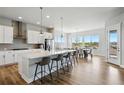 Open concept kitchen with stainless steel appliances and a large island perfect for entertaining at 18212 W 95Th Pl, Arvada, CO 80007
