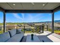 Relaxing covered deck with comfortable seating and stunning neighborhood views at 18212 W 95Th Pl, Arvada, CO 80007