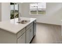 A kitchen with quartz countertops and stainless steel appliances plus a view to the outside at 1818 Sawtooth Mountain Dr, Berthoud, CO 80513