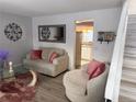 Comfortable living room featuring a cozy sofa, chair and an open view to the kitchen at 8224 Washington St # 11, Denver, CO 80229