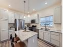 Modern kitchen featuring granite countertops, stainless steel appliances, and ample cabinet space for storage at 12920 Jasmine St # F, Thornton, CO 80602