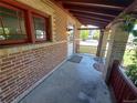 Inviting front porch with brick columns and decorative railing detail at 2902 Depew St, Wheat Ridge, CO 80214