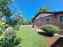 A view of the side yard with healthy green grass and tasteful landscaping at 2902 Depew St, Wheat Ridge, CO 80214