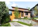 Landscaped front yard leading to a home with modern architectural details including angular rooflines and a mix of textures at 5134 Quitman St, Denver, CO 80212