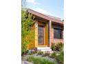 Modern front entrance featuring a stylish door with glass panels, complemented by brick and wood siding at 5134 Quitman St, Denver, CO 80212