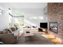 Bright living room with modern fireplace, large windows, and hardwood floors that create a spacious atmosphere at 5134 Quitman St, Denver, CO 80212