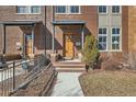 Inviting front entrance with a charming wood door and well-manicured landscaping, enhancing curb appeal at 1909 S Logan St, Denver, CO 80210