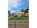 Quaint home featuring a manicured lawn and privacy fence at 951 Tennyson St, Denver, CO 80204