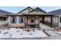Inviting front porch with seating area, perfect for enjoying quiet moments outdoors at 692 Sage Forest Ln, Monument, CO 80132