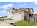 Spacious two-car garage with ample driveway space and newly installed black rain gutters at 245 Washington St, Erie, CO 80516