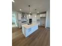 Modern kitchen featuring a large island, white cabinetry, and stainless steel appliances at 245 Washington St, Erie, CO 80516