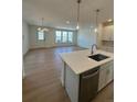 Bright living space with a kitchen island and a large sliding glass door at 245 Washington St, Erie, CO 80516
