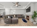 Cozy living room with a fireplace, ceiling fan, and comfortable seating perfect for relaxing at 5108 N Quatar St, Aurora, CO 80019