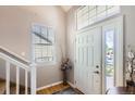 Inviting entryway with hardwood floors, natural light and a decorative vase creating a warm welcome at 11332 E 111Th Ave, Commerce City, CO 80640