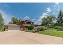 Two-story home with a driveway, garage, landscaped yard, and charming mix of brick and wood exterior at 8836 Marathon Rd, Longmont, CO 80503