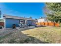 Spacious backyard with a patio set, mature trees, and a mix of gravel and grass, perfect for outdoor enjoyment at 9731 W Polk Dr, Littleton, CO 80123