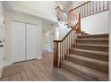 Bright foyer featuring carpeted stairs and wood-style laminate flooring at 308 Oswego St, Aurora, CO 80010