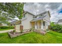 A charming home featuring a well-maintained lawn, complemented by a two-car garage and an inviting entrance at 5023 Goshawk Ct, Brighton, CO 80601