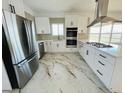 Modern kitchen featuring stainless steel appliances and marble flooring at 17362 County Road 29, Platteville, CO 80651