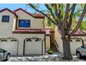Multi-Gathering townhome with three units, red tile roofs, stucco exteriors, garages and landscaped front yards at 11358 W 85Th Pl # E, Arvada, CO 80005