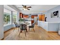 Cozy dining area with a glass table, modern chairs, and a large window for ample natural light at 14430 W Yale Pl, Lakewood, CO 80228
