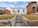 Front view of a charming bungalow with steps leading to the entrance at 2229 S Bannock St, Denver, CO 80223