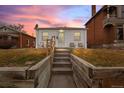 Welcoming single-story home with warm lighting, sunset, and a quaint front entrance at 2229 S Bannock St, Denver, CO 80223