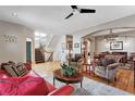 Open-concept living area with hardwood floors, staircase, and seamless flow to the dining room at 2411 S Milwaukee St, Denver, CO 80210