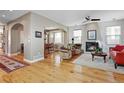 Bright living room boasts hardwood floors, a fireplace, and neutral paint, flowing into dining area at 2411 S Milwaukee St, Denver, CO 80210