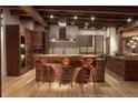 Gourmet kitchen featuring a large island, wood cabinets and stainless steel appliances at 1628 14Th St # 6A, Denver, CO 80202