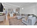 Open-concept living room seamlessly connects to the kitchen with modern gray color palette at 16347 E 111Th Dr, Commerce City, CO 80022