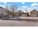 Home exterior featuring a spacious driveway and well-maintained landscaping at 23590 E Jamison Pl, Aurora, CO 80016