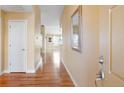 Bright hallway featuring wood floors, neutral paint and access to main living areas at 23590 E Jamison Pl, Aurora, CO 80016