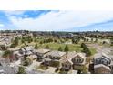 Panoramic aerial showcases a neighborhood with manicured lawns, mature trees, a green park, and a community pool at 7004 S Addison Ct, Aurora, CO 80016