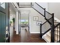 Spacious foyer featuring hardwood floors, staircase and view into the living room at 16069 Pikes Peak Dr, Broomfield, CO 80023