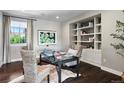 Cozy home office features a stylish desk, built-in shelving, and natural light at 16069 Pikes Peak Dr, Broomfield, CO 80023
