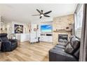 Spacious living room with fireplace, ceiling fan and hardwood floors at 9139 Flora St, Arvada, CO 80005