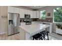 Beautiful kitchen featuring stainless steel appliances, a center island with seating, and sleek finishes at 1310 Hoyt St # 6, Lakewood, CO 80215
