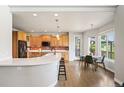 Well-lit kitchen with wood cabinets, stainless steel appliances, and breakfast nook at 9467 W Plymouth Ave, Littleton, CO 80128