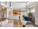 Bright, open living room with hardwood floors, stone fireplace, and vaulted ceilings at 9467 W Plymouth Ave, Littleton, CO 80128
