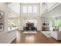 Spacious living area with a fireplace, soaring ceilings, and large windows at 9467 W Plymouth Ave, Littleton, CO 80128
