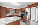 Stylish kitchen boasts granite countertops, stainless steel appliances, and custom cabinetry at 14190 E Gunnison Pl, Aurora, CO 80012
