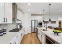 Modern kitchen with stainless steel appliances, white cabinets, and a stylish backsplash at 42973 Colonial Trl, Elizabeth, CO 80107