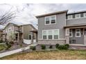 Two-story home with neutral siding, brick accents, a walkway and landscaping in a neighborhood at 5152 Bittercress Rd, Brighton, CO 80640